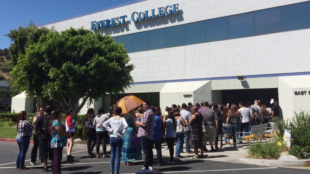 Students wait in 2015 outside Everest College in Industry, hoping to get transcriptions and information on loan forgiveness and transferring credits to other schools. Everest was one of several for-profit colleges shut down after parent Corinthian Colleges filed for bankruptcy.