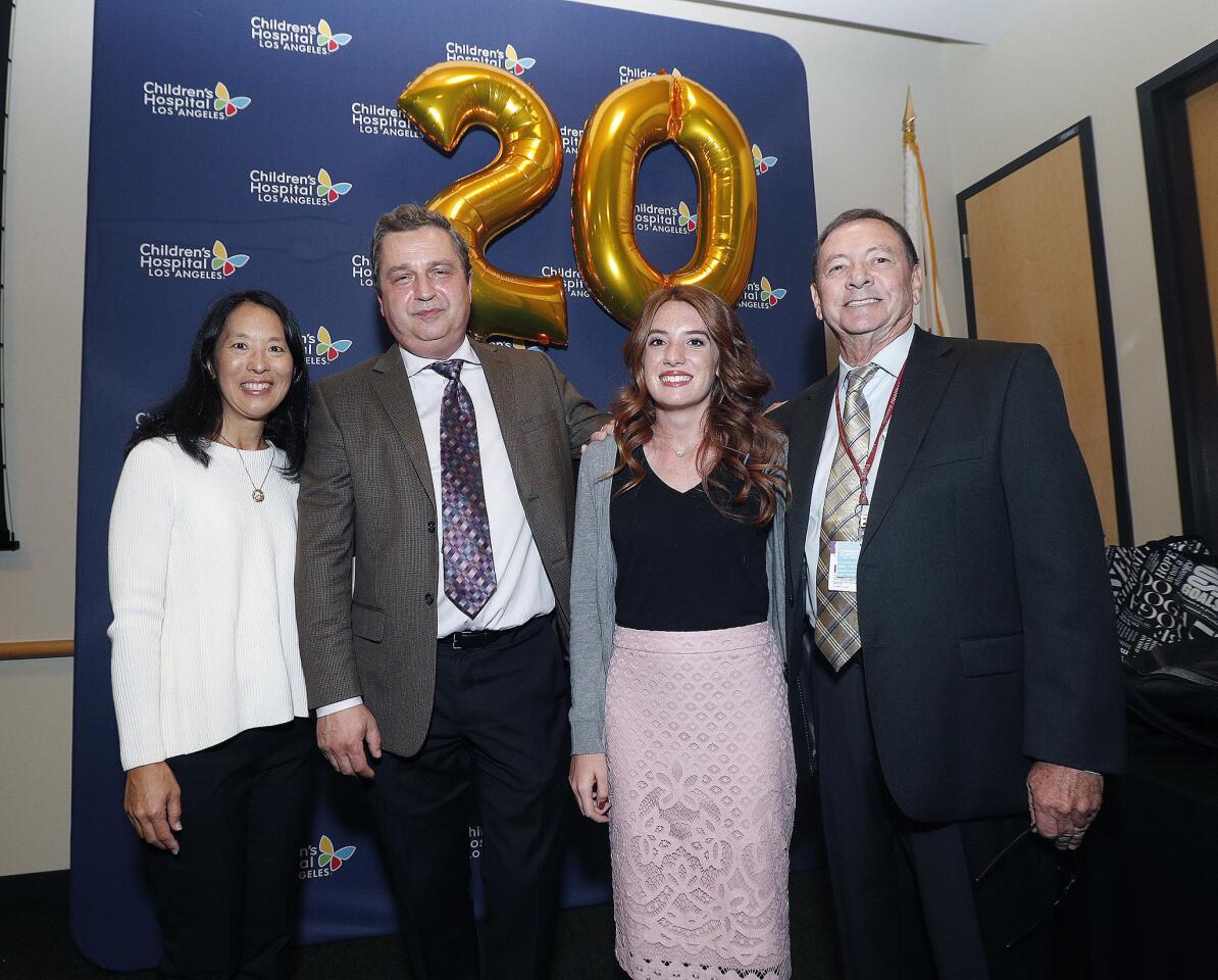 Lydia Hand, of Lancaster, in pink skirt, stands with her 1998 transplant team of Ardeth Yamaga, who was the first fellow on the team, Dr. Daniel Thomas, MD, and Yuri Genyk, MD, at the 20-year anniversary of the first liver transplant, at Children's Hospital Los Angeles on Friday, October 5, 2018. Liver transplant recipients were in attendance, from the first one done at CHLA to the most recent.