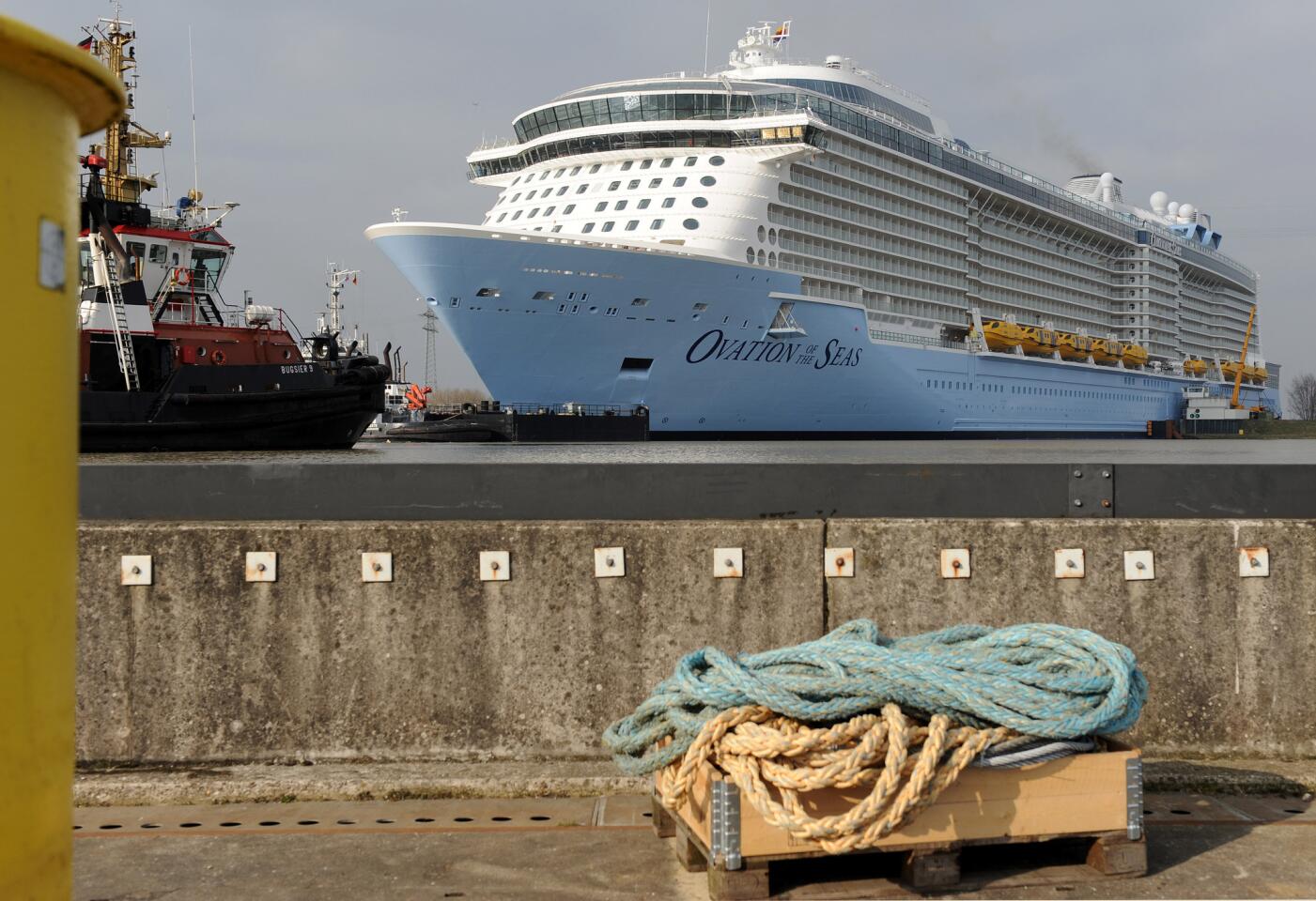 The newest cruise ship of the Meyer Werft shipyard, Ovation of the Seas, is prepared for its transfer to the North Sea on the Ems River in Papenburg, Germany, Friday March 11, 2016. The 348 meter long passenger ship is heading to the Dutch city of Eemshaven first and will later continue to the Bremerhaven, Germany to be prepared for the delivery to Royal Caribbean International.
