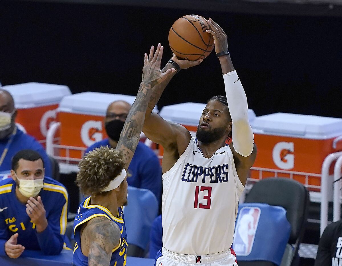 The Clippers' Paul George, who scored a team-best 25 points, attempts a three-point shot over the Warriors' Kelly Oubre Jr.