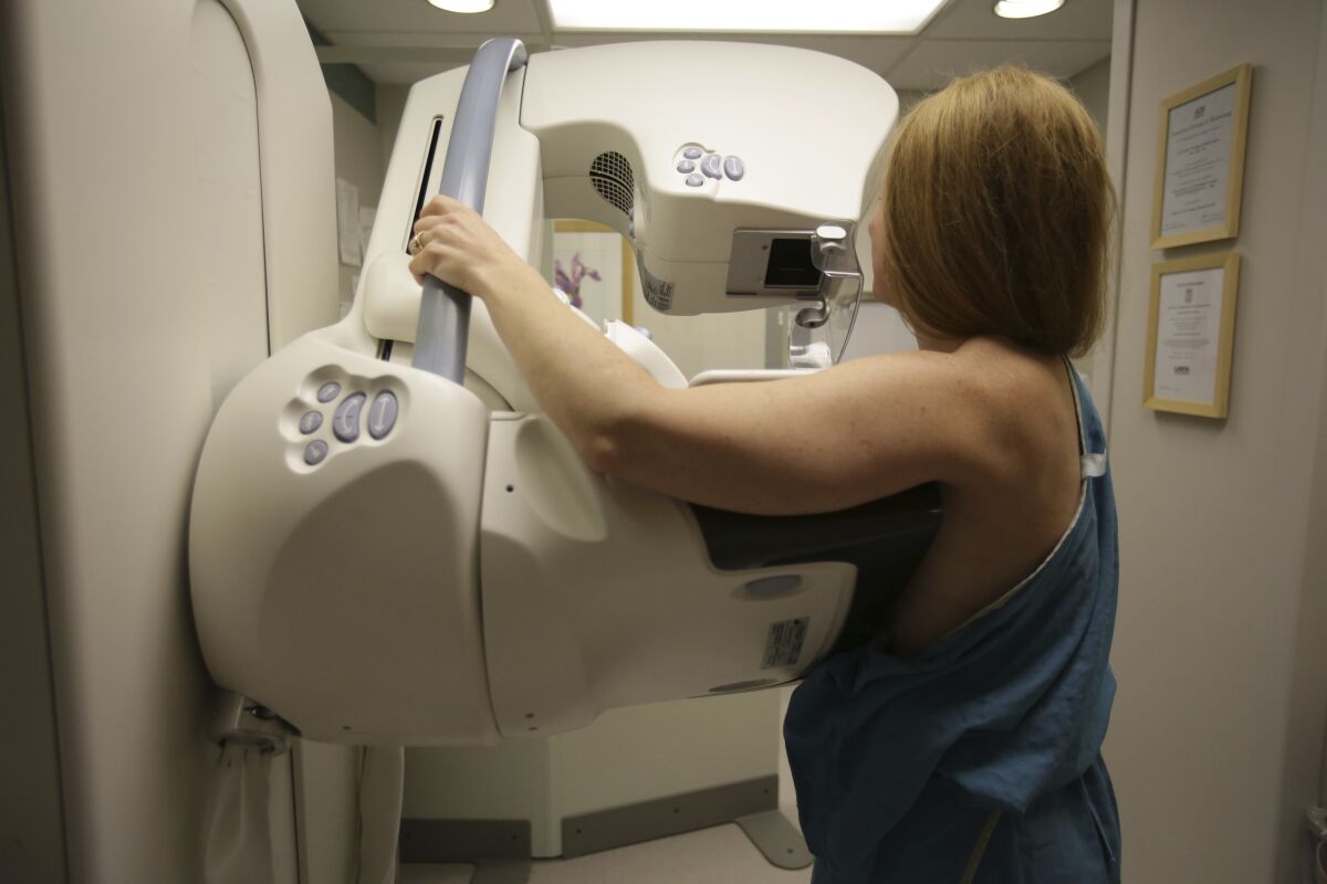 A woman gets a mammogram at the University of Michigan Cancer Center in Ann Arbor, Mich. Doctors are reporting unusually good results from tests of two experimental drugs in women with an aggressive form of breast cancer.