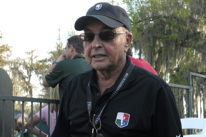 FILE - Tavistock founder Joe Lewis stands on the 18th green after the second day of the Tavistock Cup golf tournament in Windermere, Fla., March 15, 2011. British billionaire and Tottenham soccer team owner Joe Lewis has been indicted in the U.S. on charges of slipping confidential business information to people ranging from his romantic partners to his private pilots, prosecutors said Tuesday, July 25, 2023. (AP Photo/Phelan M. Ebenhack, File)