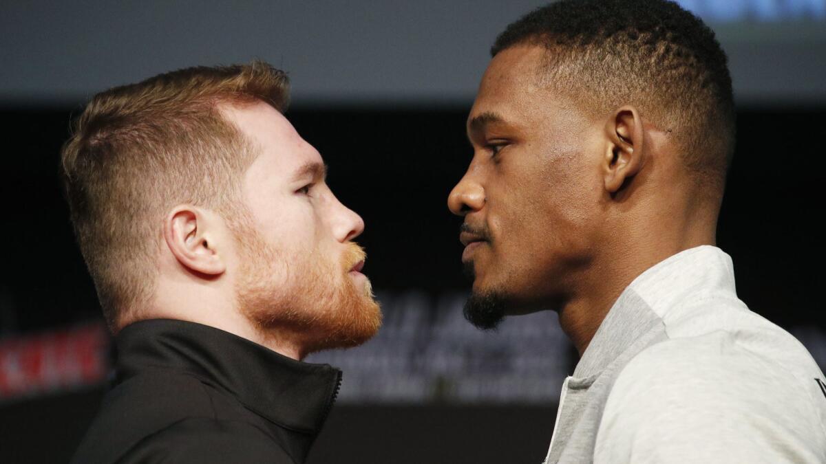Boxers Canelo Alvarez, left, and Daniel Jacobs pose at a news conference Wednesday in Las Vegas.