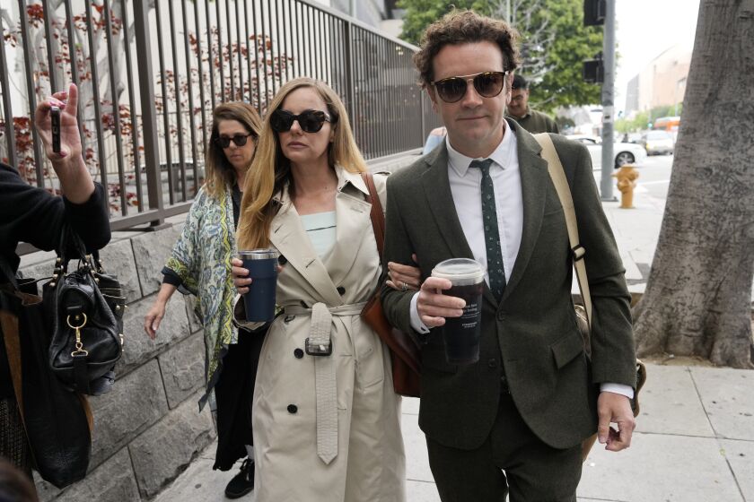 FILE - Danny Masterson, right, and his wife Bijou Phillips arrive for closing arguments in his second trial, May 16, 2023, in Los Angeles. A jury found “That ’70s Show” star Masterson guilty of two counts of rape Wednesday, May 31, in a Los Angeles retrial in which the Church of Scientology played a central role. (AP Photo/Chris Pizzello, File)