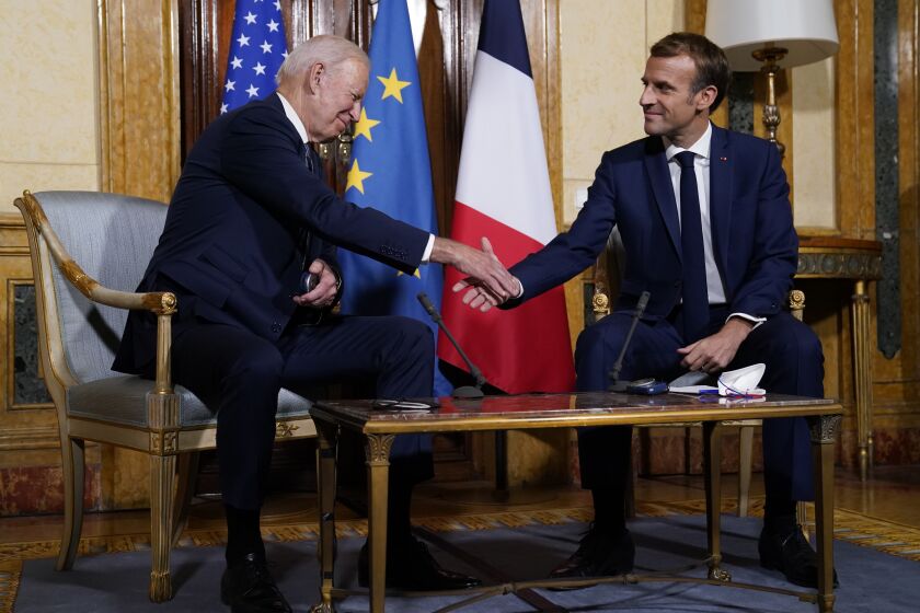 U.S. President Joe Biden, left, shakes hands with French President Emmanuel Macron during a meeting at La Villa Bonaparte in Rome, Friday, Oct. 29, 2021. A Group of 20 summit scheduled for this weekend in Rome is the first in-person gathering of leaders of the world's biggest economies since the COVID-19 pandemic started. (AP Photo/Evan Vucci)
