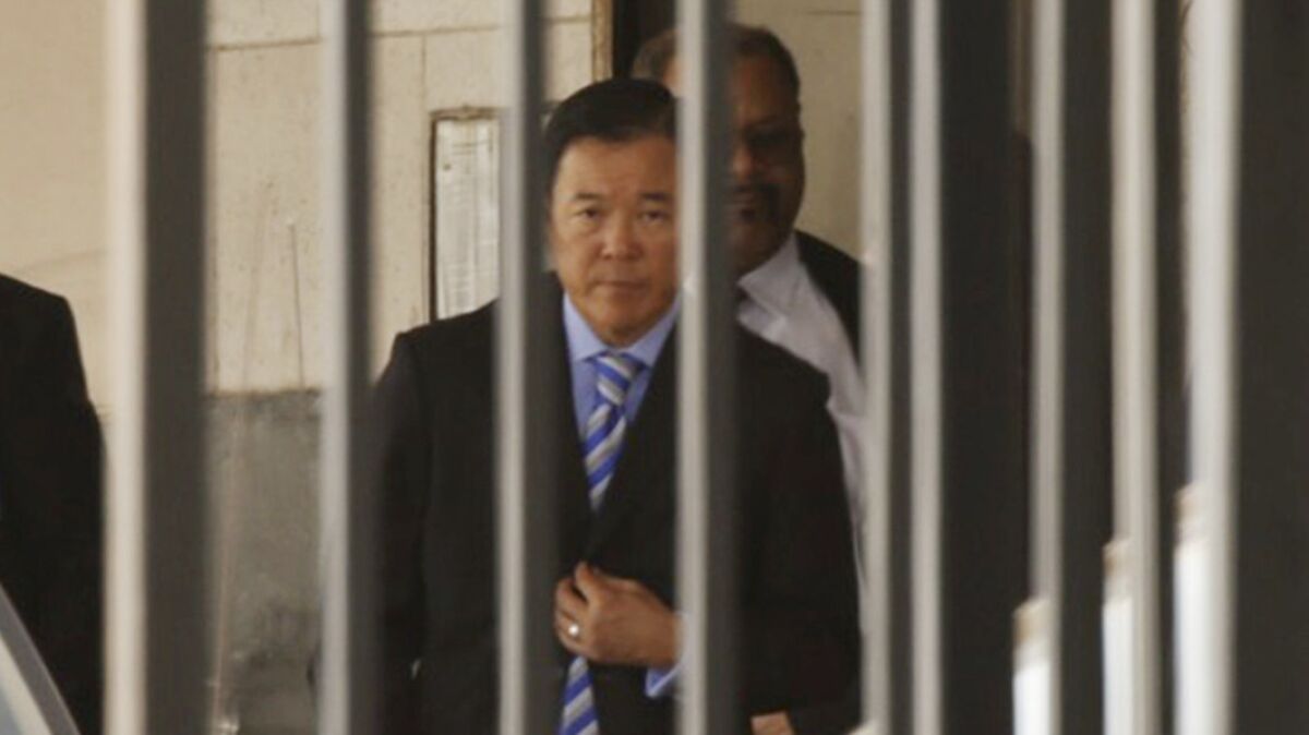 Paul Tanaka leaves court after being sentenced Monday to five years in prison.