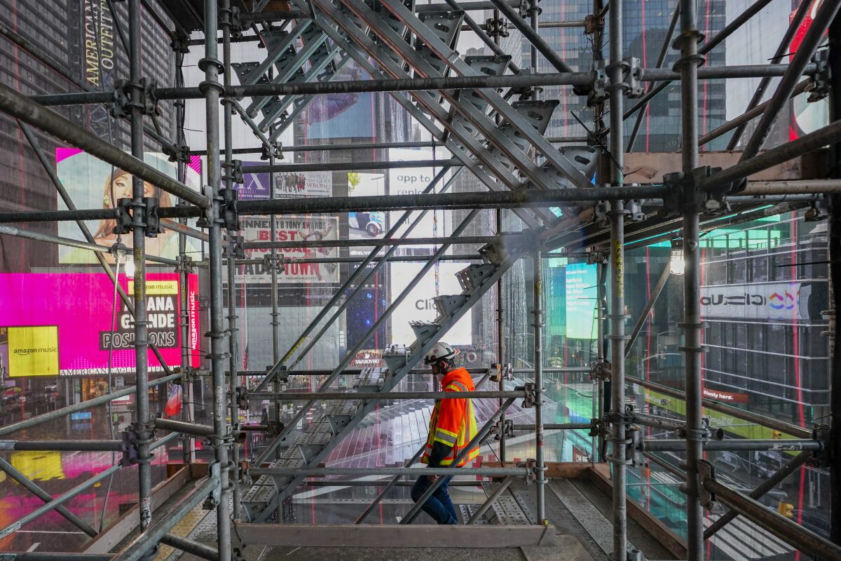 A construction worker walks down a staircase in the scaffolding of TSX Broadway under construction, Thursday, Oct. 29, 2020, in New York's, Times Square. The 46-story mixed-use property will house 75,000 square feet of retail space, a 4,000-square-foot performance venue including an outdoor stage, an outdoor food and beverage terrace and a luxury hotel. U.S. construction spending rose 0.3% in September, the fourth straight monthly gain after a coronavirus-caused spring swoon. (AP Photo/Mary Altaffer)
