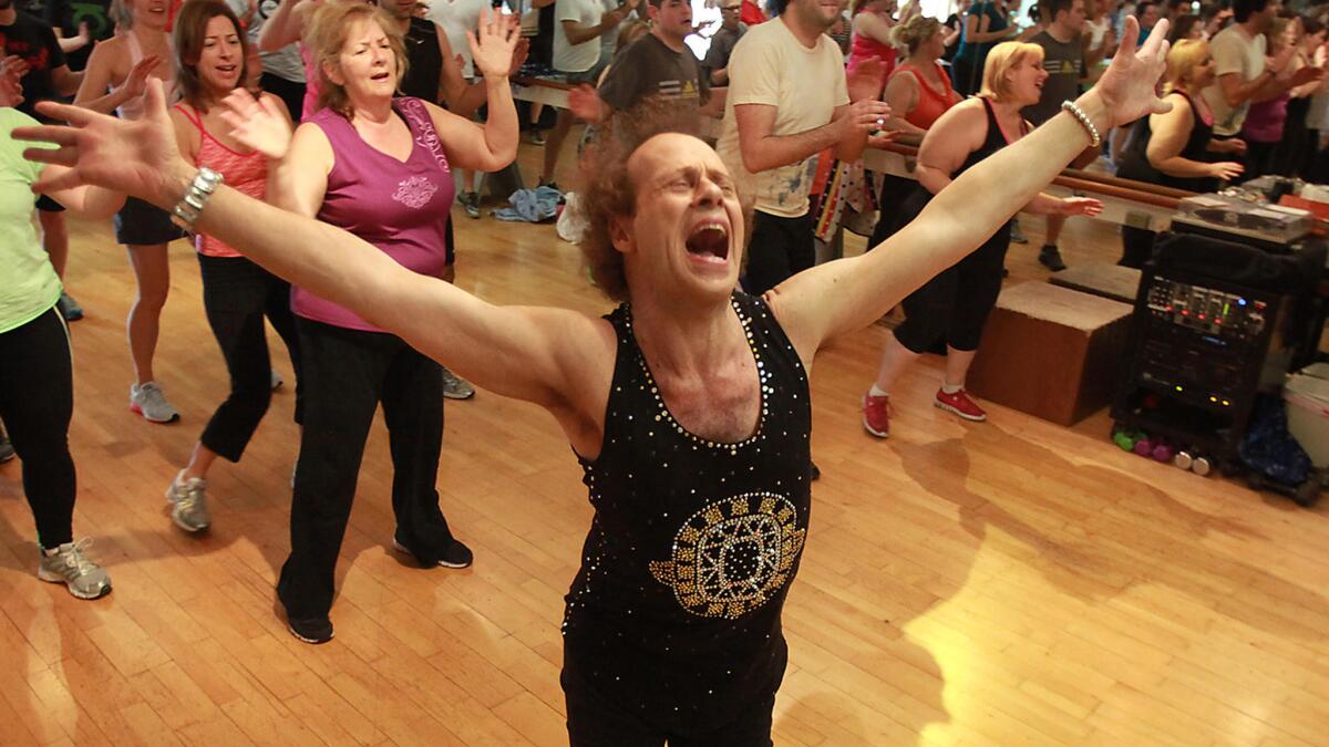 Richard Simmons sings along with the music as he teaches a class in Beverly Hills in 2013.