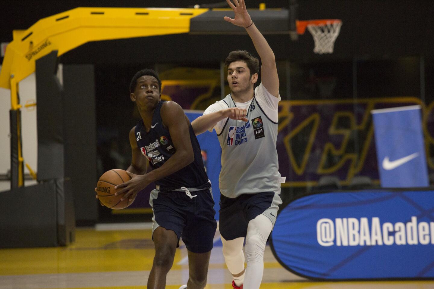 Malcolm Tungo of Angola drives to the basket against Mert Akay of Turkey during the global camp.