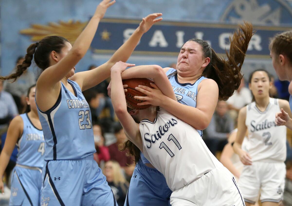 Newport Harbor's Chloe Swanson (11) and Corona del Mar's Makena Tomlinson fight for the ball in the Battle of the Bay game on Thursday.