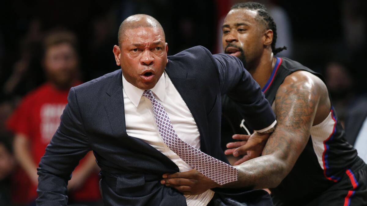 Clippers Coach Doc Rivers is restrained by center DeAndre Jordan after receiving two technical fouls and getting ejected from a Nov. 29 game against the Nets.