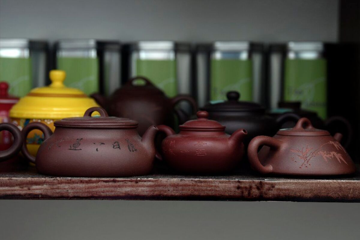 Clay pots fill shelves at Tea Habitat.