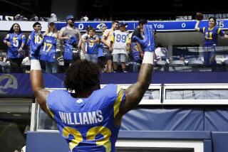 Rams running back Kyren Williams (23) cheers with the crowd after leading a win over the Cardinals.
