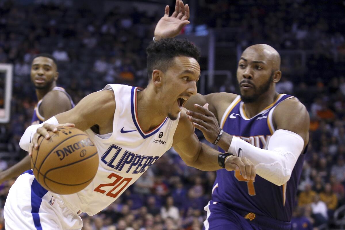 Clippers guard Landry Shamet drives past Suns guard Jevon Carter during their game Oct. 26, 2019, in Phoenix.