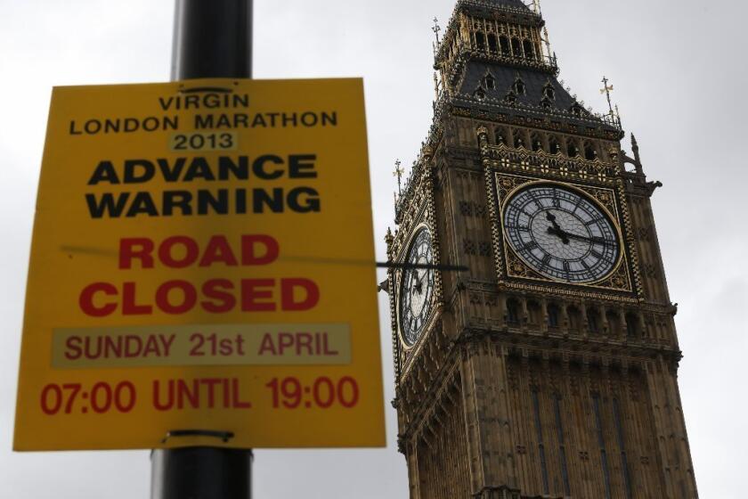 With Big Ben in the background, a sign warns of road closures for the coming London Marathon.