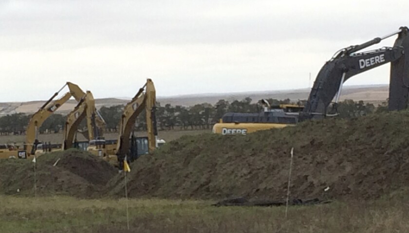 Excavators are in place as work resumed Tuesday on the four-state Dakota Access pipeline near St. Anthony, N.D.