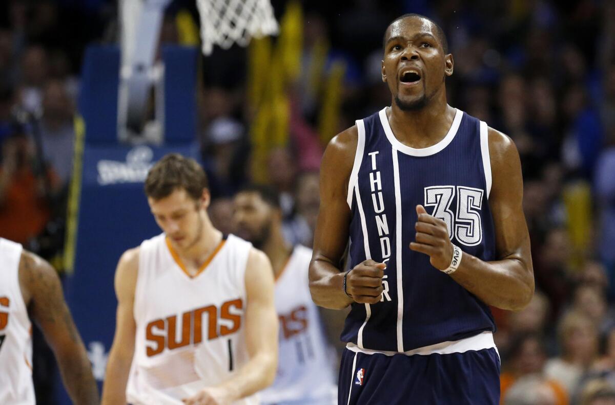 Thunder forward Kevin Durant reacts after making a foul shot during overtime in a 137-134 victory over the Suns on Wednesday night.