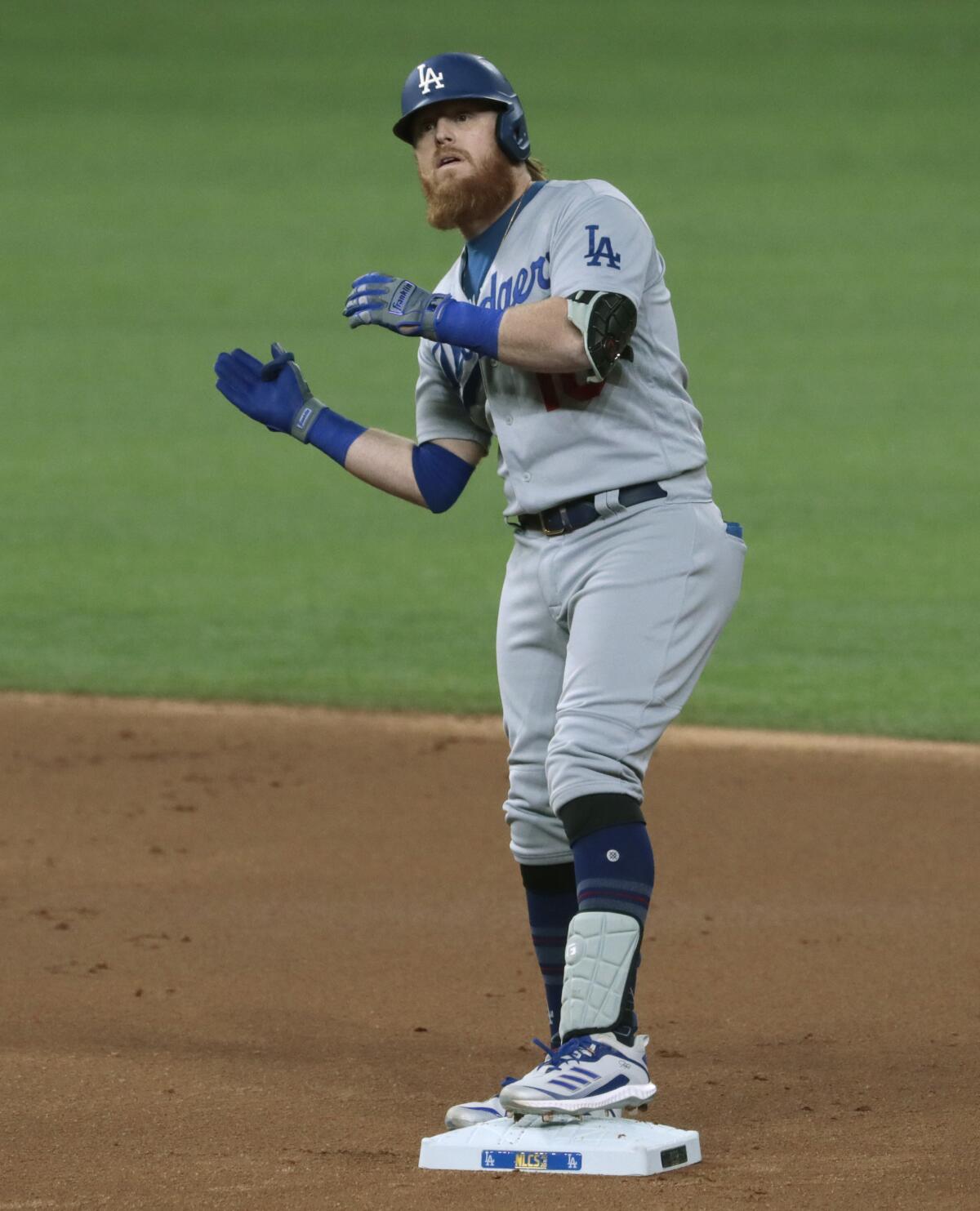 Dodgers third baseman Justin Turner celebrates after hitting a double in the first inning against the Braves.