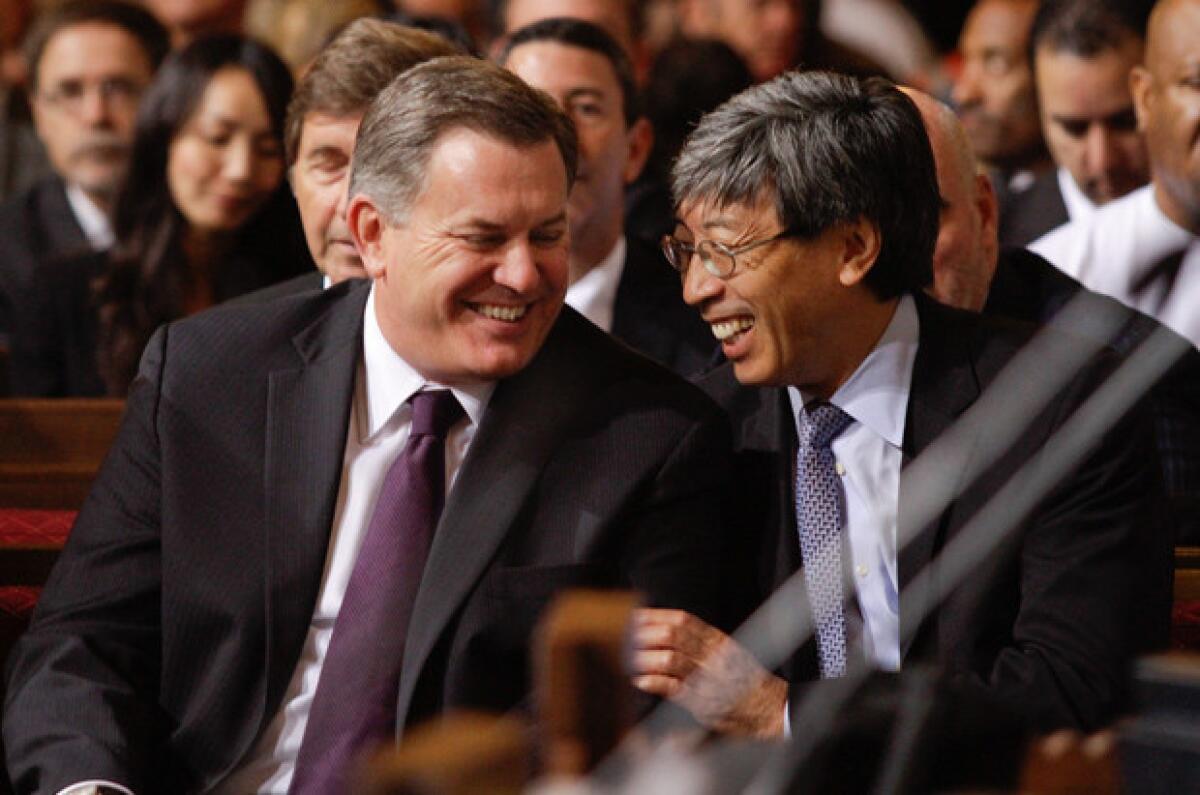 AEG chief Tim Leiweke sits next to Patrick Soon-Shiong at Los Angeles City Hall during a council vote on documents that would pave the way for the construction of a football stadium in downtown L.A.