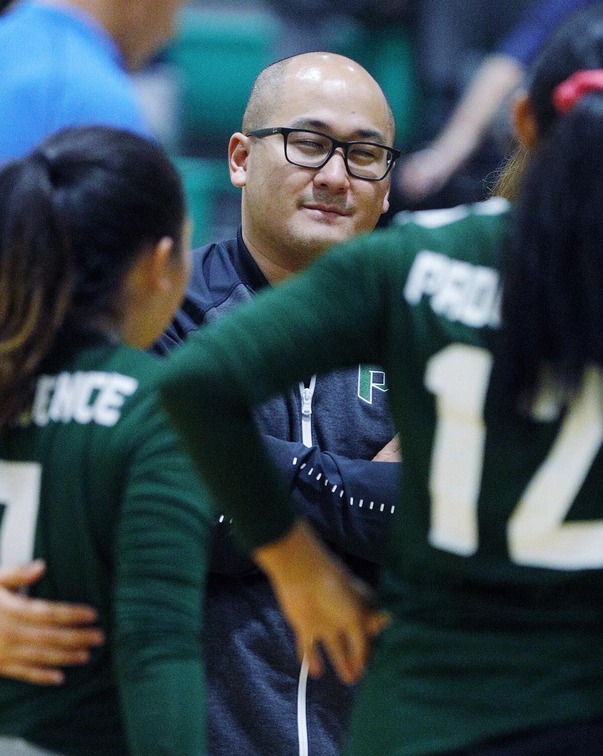 Providence's head coach James Jimenez gathers his team during a timeout in the match with Polytechnic at a Prep League girls' volleyball match at Providence High School on Tuesday, September 17, 2019.