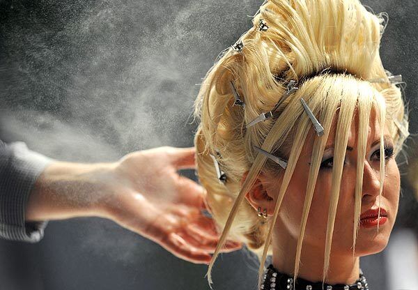 A designer prepares a hair creation during Cristal Angel, the 9th International Festival of Hairdresser Art, in Kiev, Ukraine.