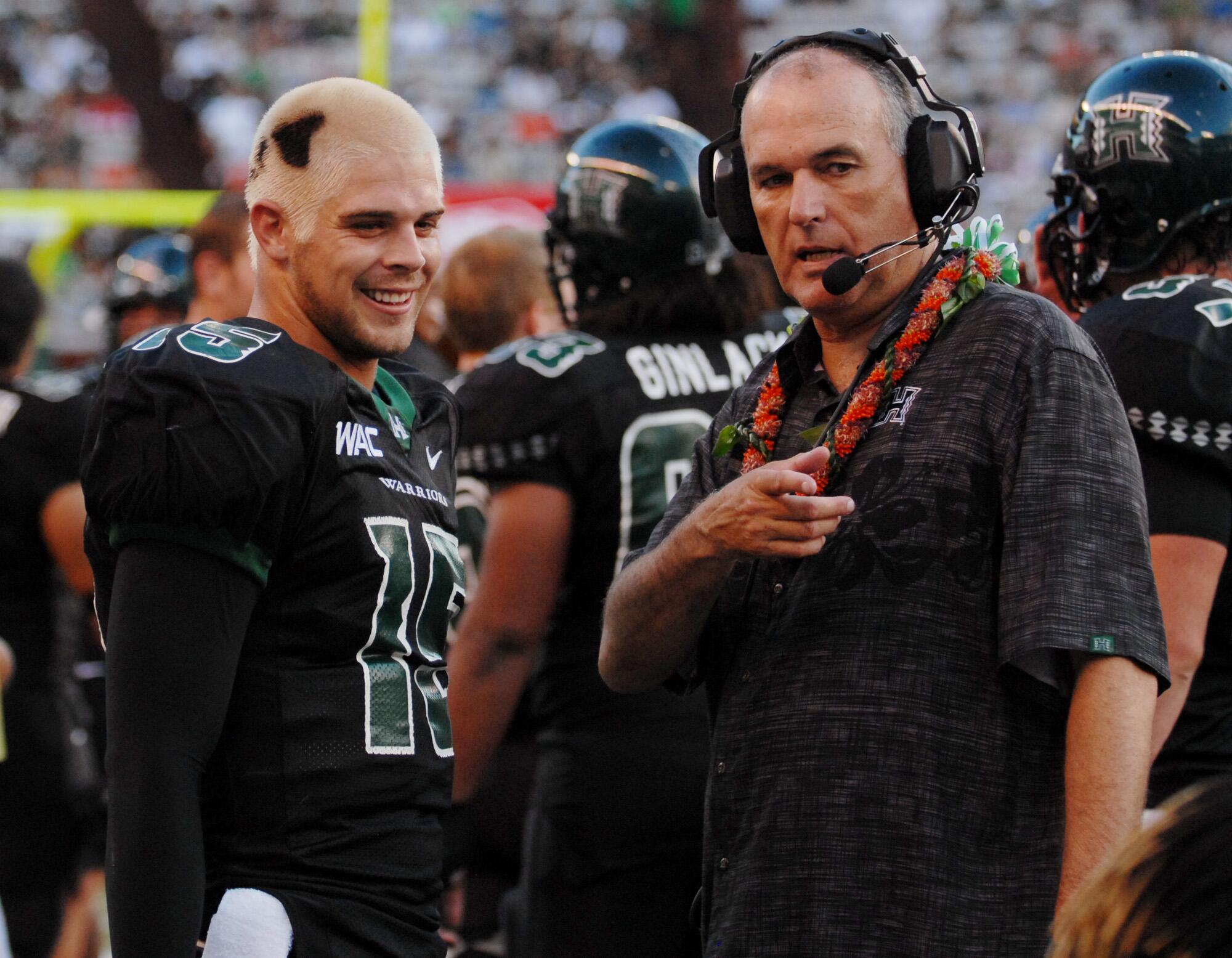 Hawaii quarterback Colt Brennan, left, and coach June Jones talk during a game against Northern Colorado on Sept. 1, 2007.