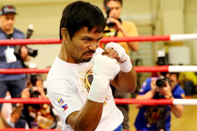 Manny Pacquiao shadow boxes during a training session in Maco.