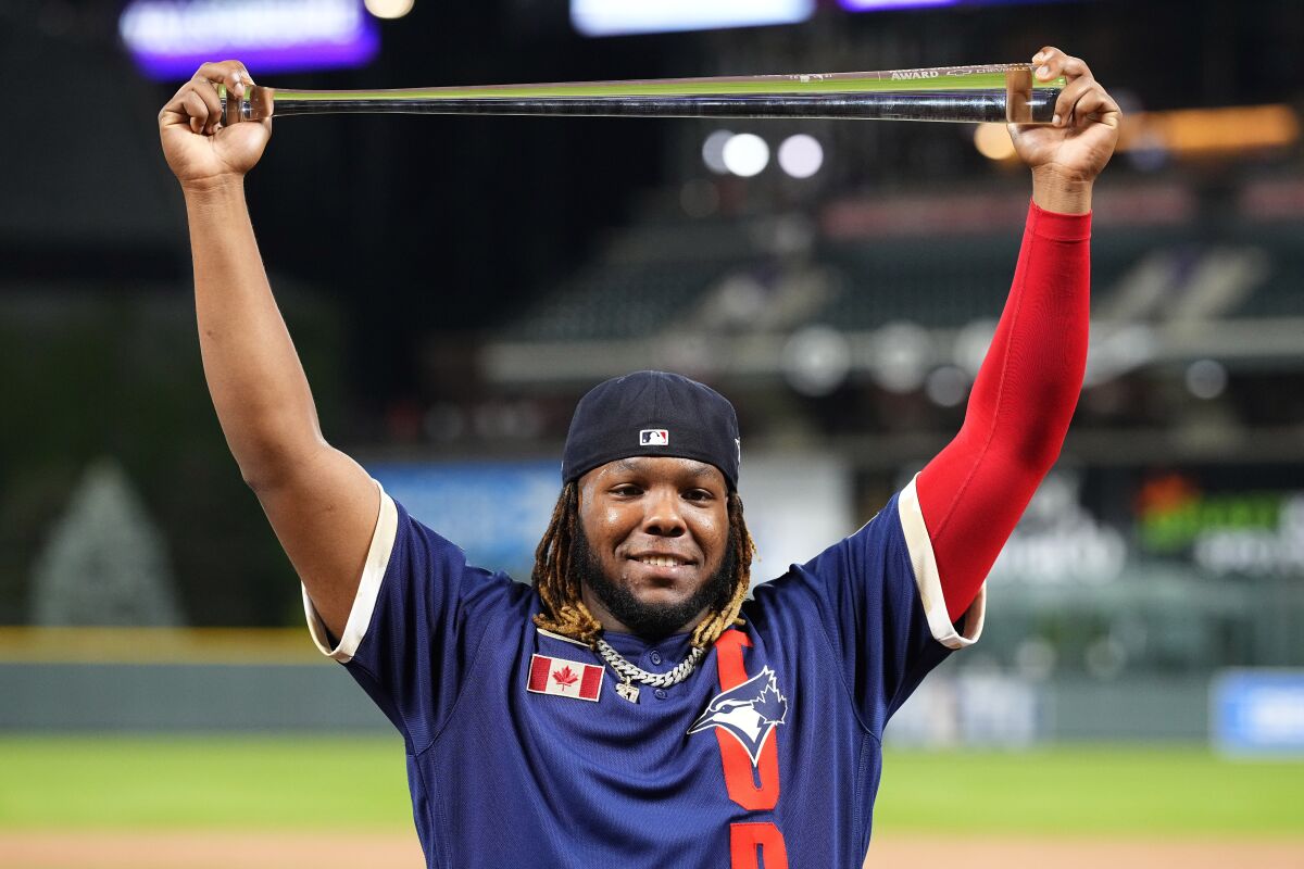 American League's Vladimir Guerrero Jr., of the Toronto Blue Jays, holds the MVP trophy after the MLB All-Star baseball game, Tuesday, July 13, 2021, in Denver. (AP Photo/Jack Dempsey)