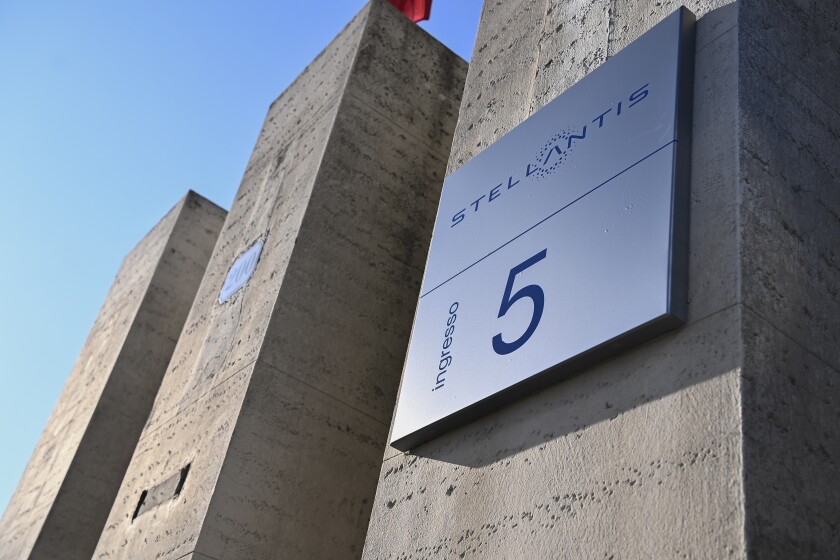 FILE - In this Jan. 18, 2021 file photo, the Stellantis logo is seen on a building of the historic Mirafiori headquarters in Turin, Italy, the day of the company's stock market debut. On Wednesday, May 5, 2021 the Stellantis automotive company, created out of the merger of Fiat Chrysler Automobiles and PSA Peugeot, reported a 14% increase in first-quarter revenues, despite a drop in production due to the semiconductor shortage. (Marco Alpozzi/LaPresse via AP, file)