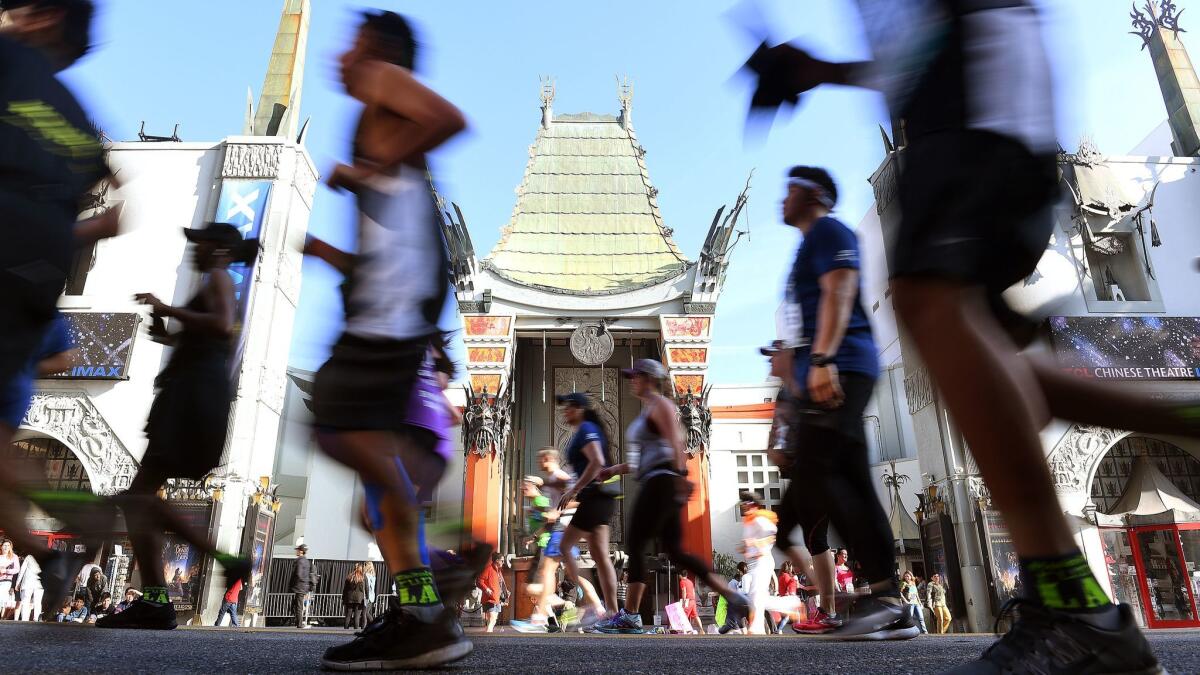 Race participants pass by Grauman's Chinese Theater during the 32nd annual Los Angeles Marathon.