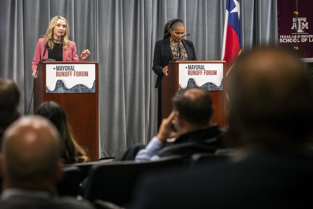 Mattie Parker, left, and Deborah Peoples answer questions on issues facing the business community during the mayoral runoff forum Wednesday, May 12, 2021, at Texas A&M University School of Law, in Fort Worth, Texas. Fort Worth is electing a new mayor Saturday, June 5. (Yffy Yossifor/Star-Telegram via AP)