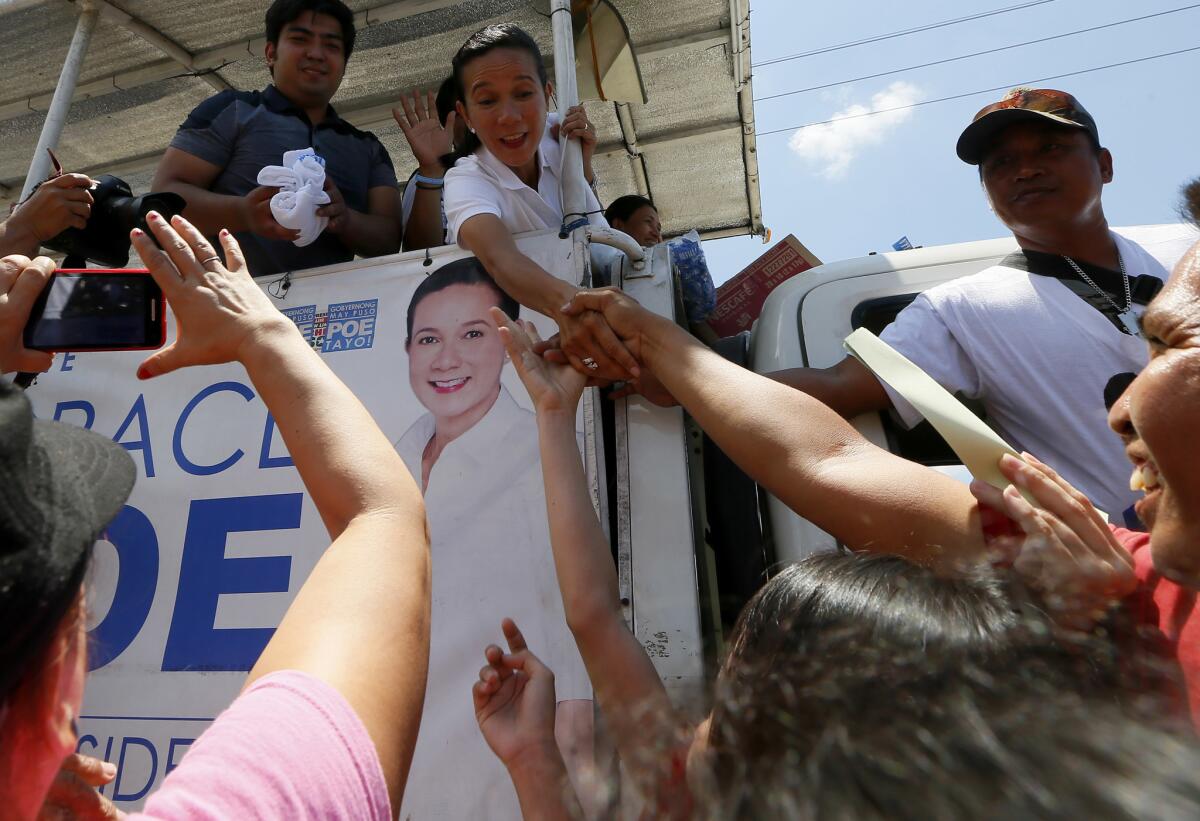 Presidential candidate Sen. Grace Poe shakes hands with supporters.