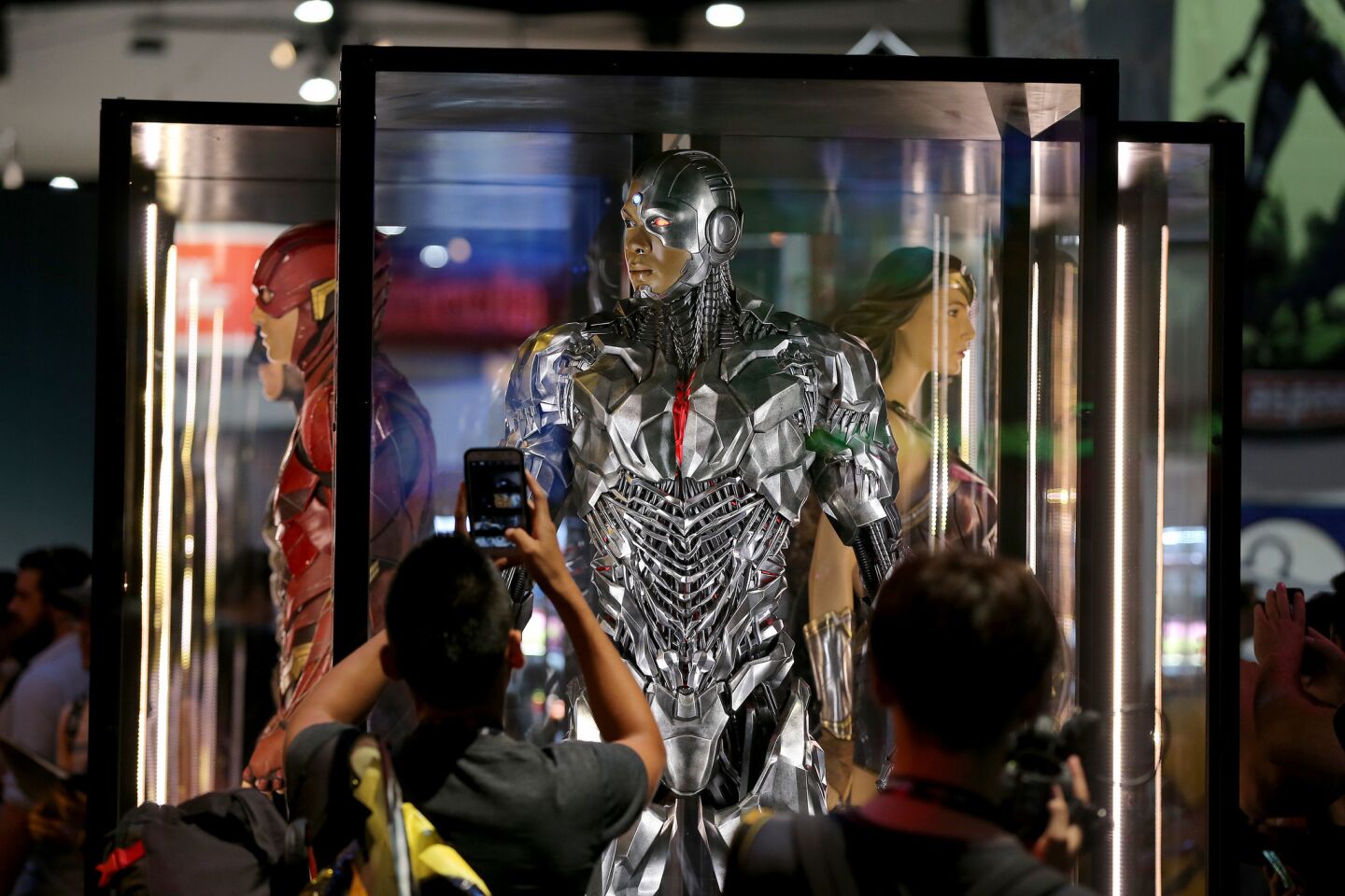 Fans view a DC Comics display of Cyborg, center, and others during preview night at Comic Con.