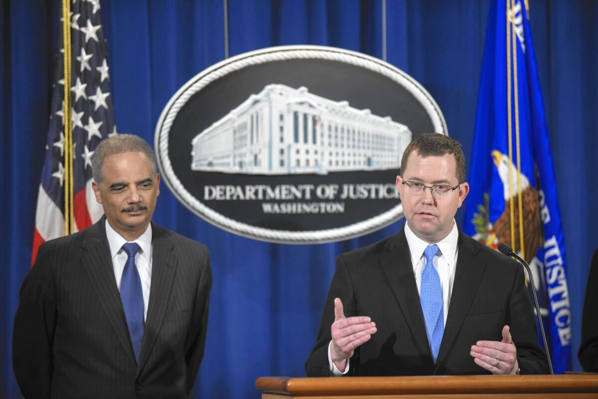 At a news conference in Washington, Acting Associate Atty. Gen. Stuart F. Delery, right, said of the Standard & Poor’s settlement: “We brought this case because S&P committed fraud.” Atty. Gen. Eric H. Holder Jr. is at left.