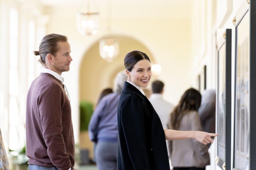 Actress Sophia Bush, right, and her fiancé Grant Hughes, left, take a public tour of the White House, Friday, April 29, 2022, in Washington. (AP Photo/Andrew Harnik)