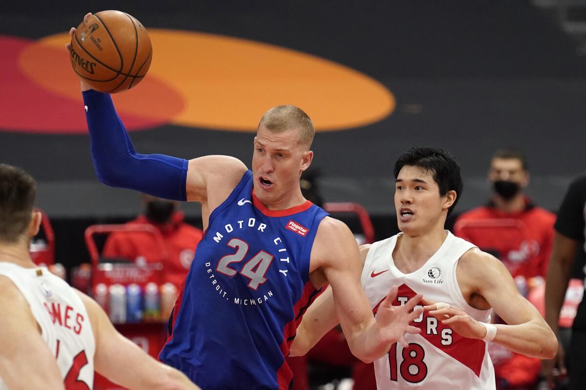 Detroit Pistons center Mason Plumlee (24) grabs a rebound from Toronto Raptors forward Yuta Watanabe, of Japan, (18) during the first half of an NBA basketball game Wednesday, March 3, 2021, in Tampa, Fla. (AP Photo/Chris O'Meara)