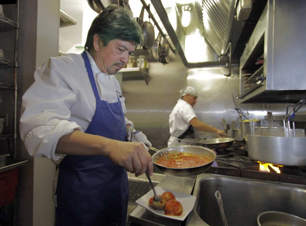 Chef and owner Andre Guerrero in the kitchen of his new Highland Park restaurant, which specializes in Italian-American food.