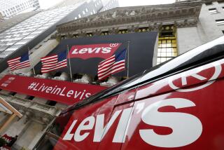FILE - A Levi's banner adorns the facade of the New York Stock Exchange, March 21, 2019. Denim giant Levi Strauss & Co. said Thursday, Jan. 25, 2024, that it's slashing its global corporate workforce by 10% to 15% in the first half of the year as part of a two-year restructuring plan that seeks to simplify its operations. (AP Photo/Richard Drew, File)