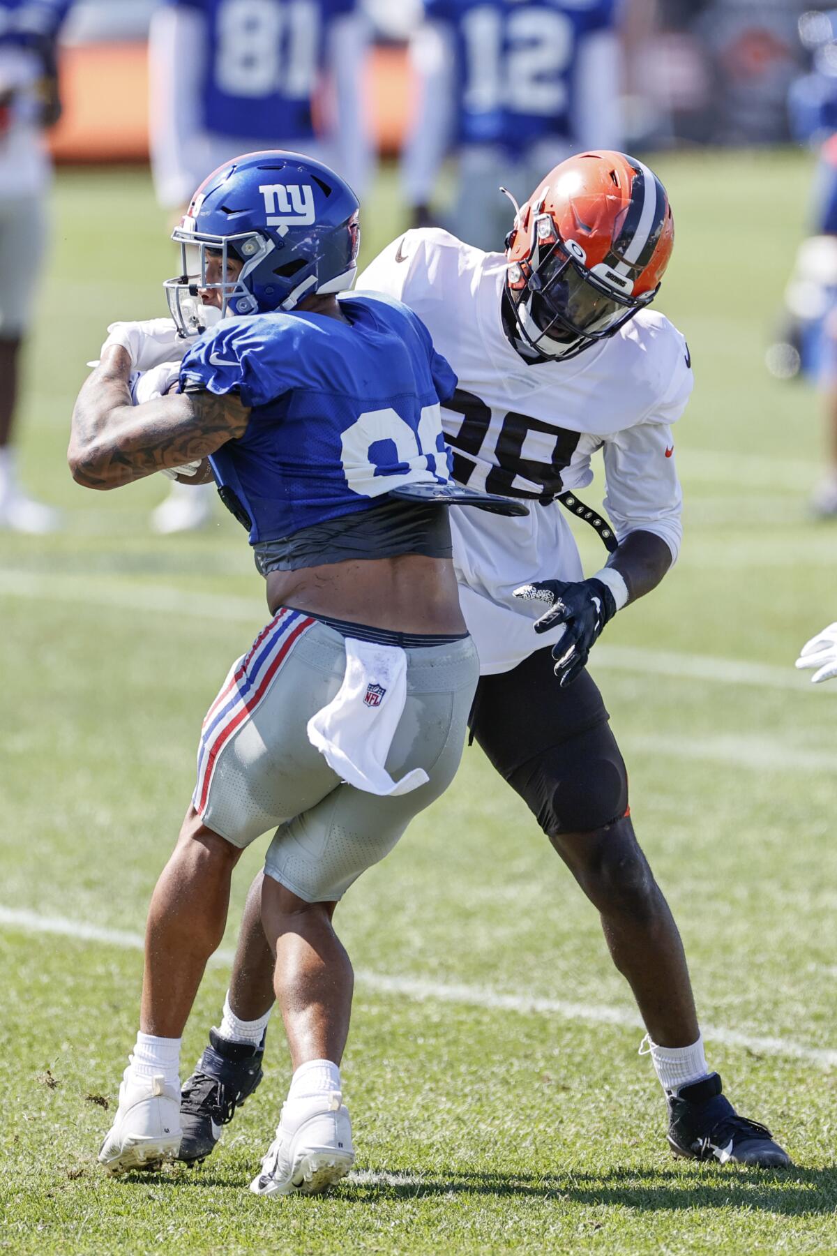 Cleveland Browns linebacker Jeremiah Owusu-Koramoah (28) stops New York Giants tight end Evan Engram (88) during a joint NFL football training camp practice Friday, Aug. 20, 2021, in Berea, Ohio. (AP Photo/Ron Schwane)