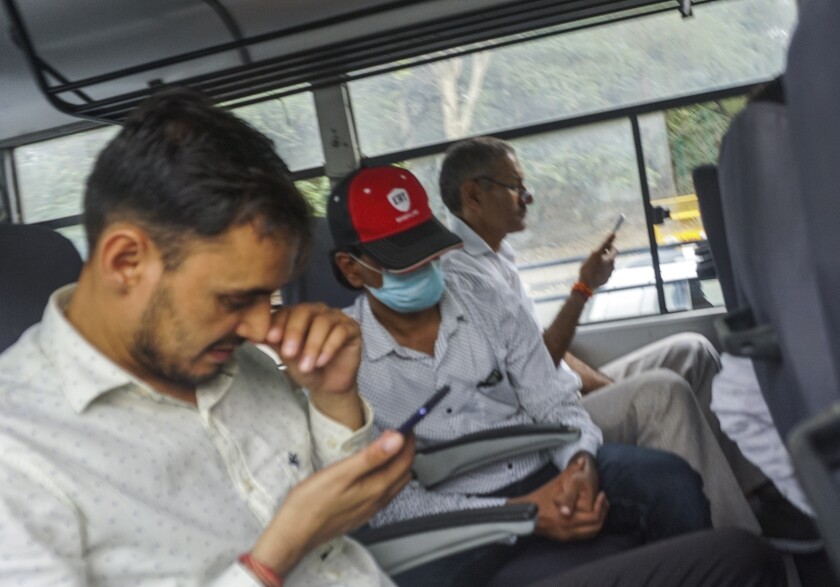 FILE- Indian journalist Mohammed Zubair, center, wearing cap, sits in a police vehicle after being produced in a court in New Delhi, India, June 28, 2022. India’s top court Wednesday granted bail to the Muslim journalist and ordered his release from jail, more than three weeks after he was detained for allegedly hurting religious sentiments through his tweets. (AP Photo/Dinesh Joshi, File)