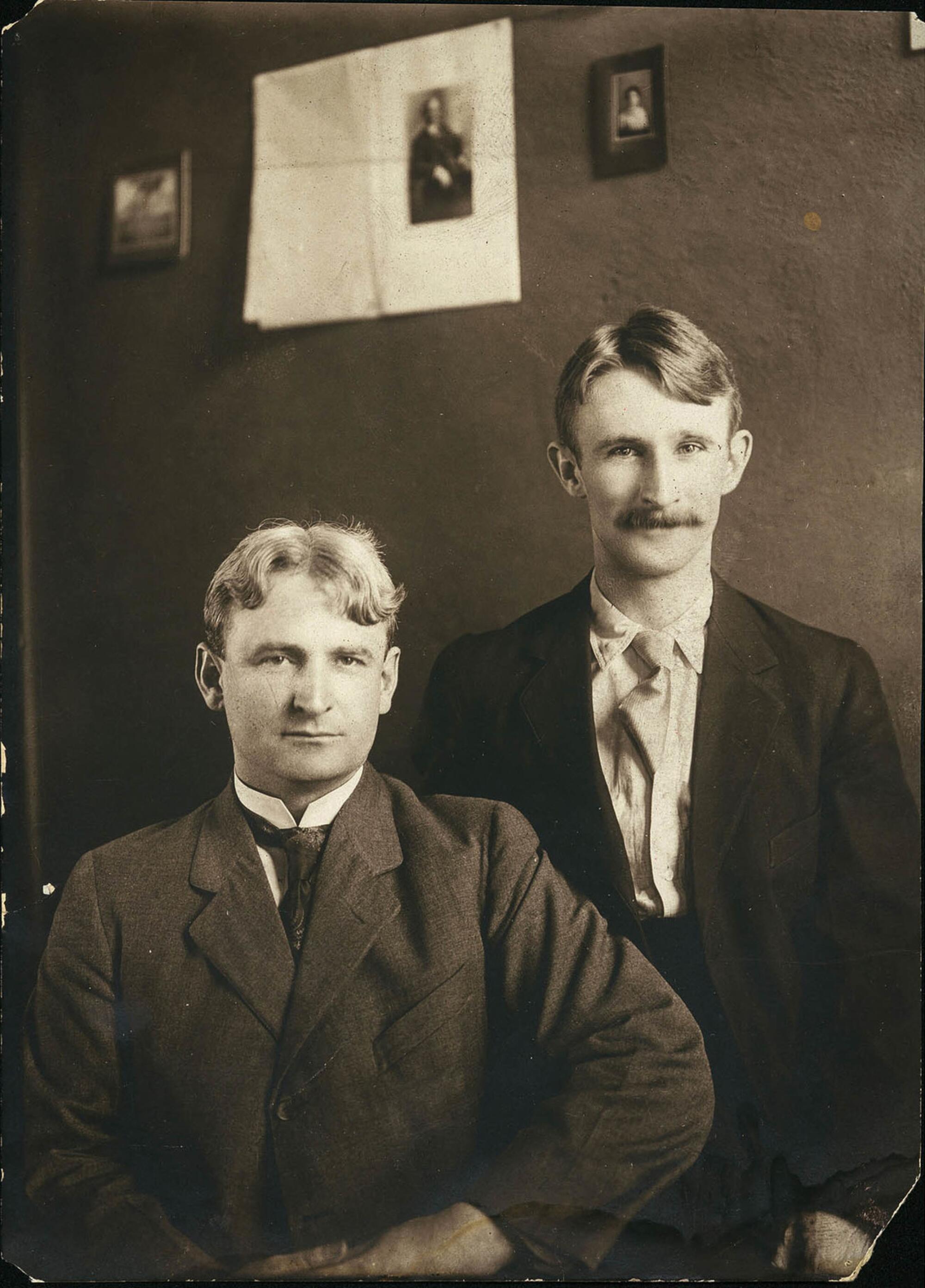A black-and-white photo of John J. McNamara, seated, and James B. McNamara standing on one side behind him.