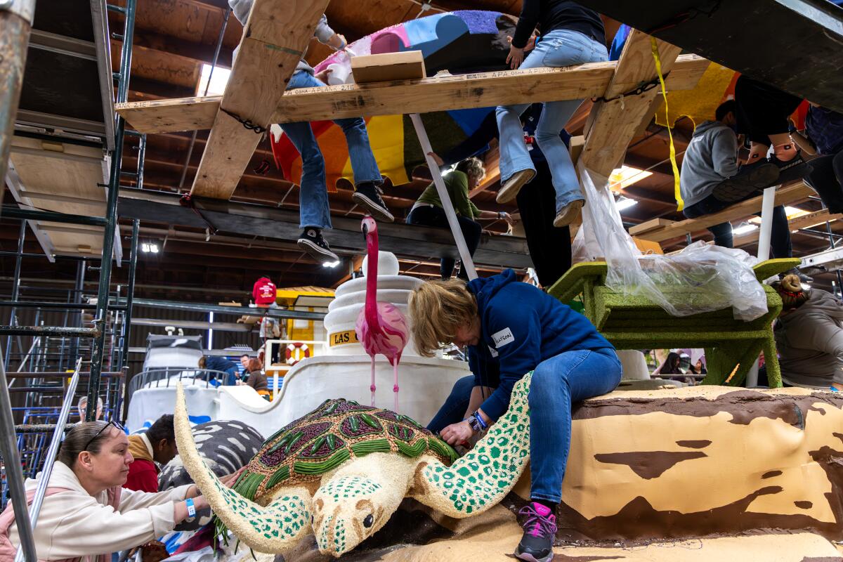 Volunteers work on Fort Lauderdale float for Rose parade "Visit Lauderdale