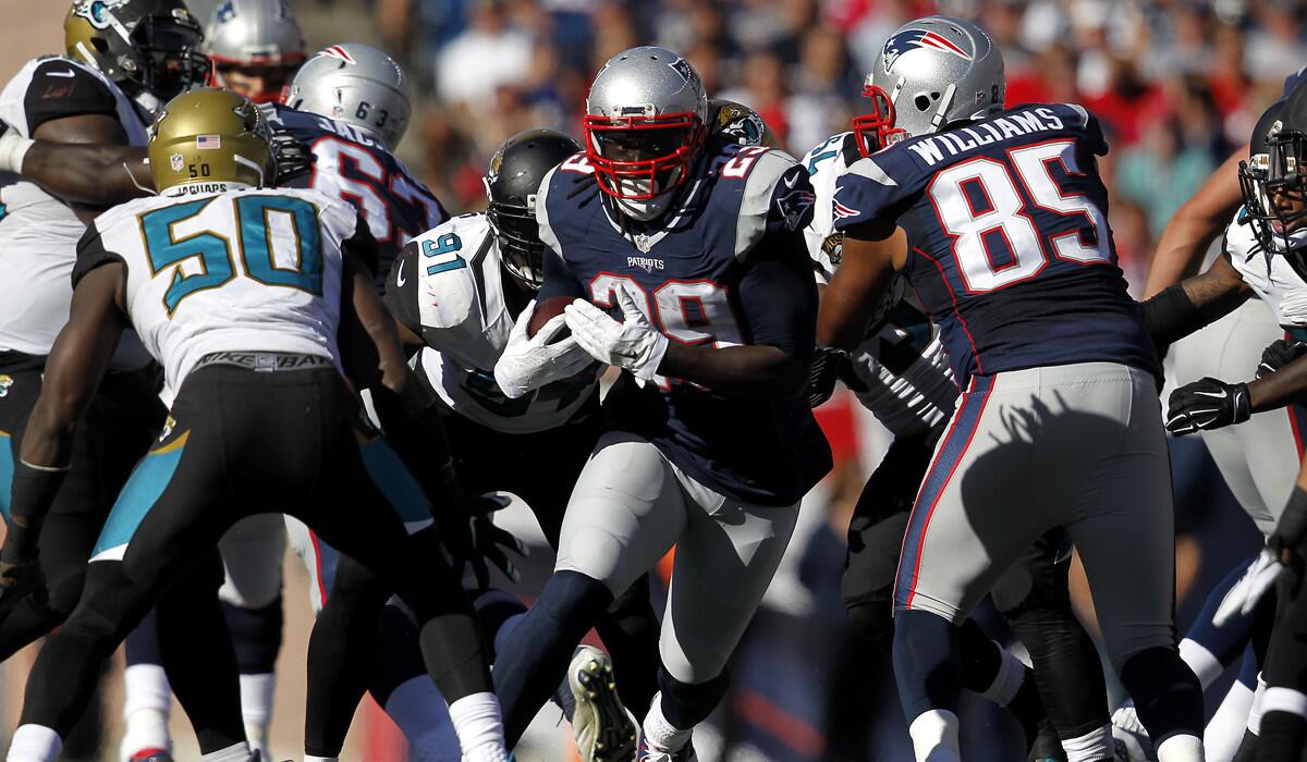 New England Patriots running back LeGarrette Blount runs through Jacksonville Jaguars defenders on Sept. 27.