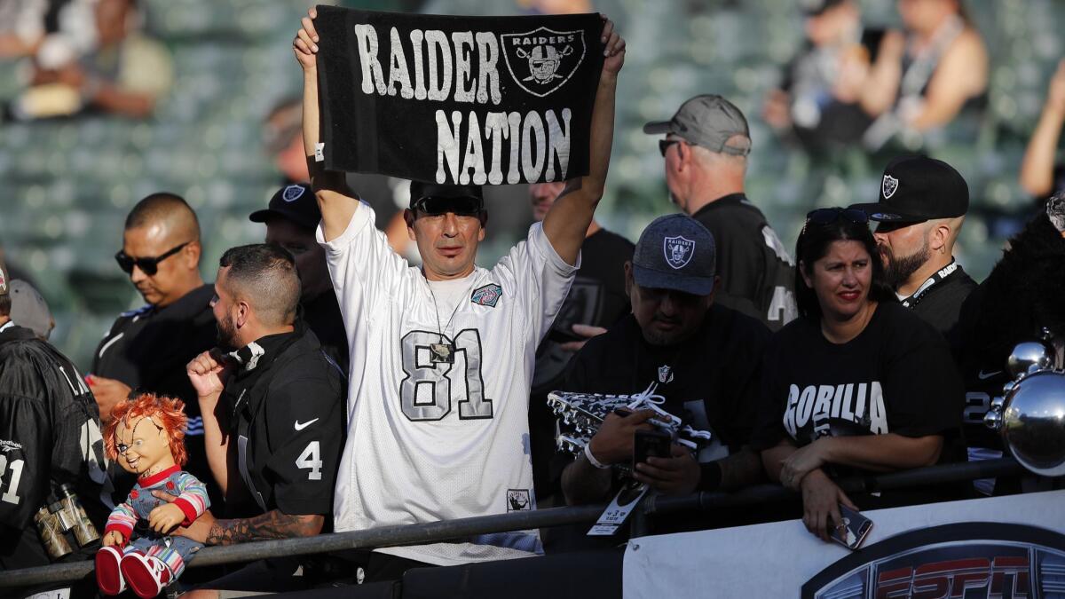 An Oakland Raiders fan shows his pride during warmups Monday.