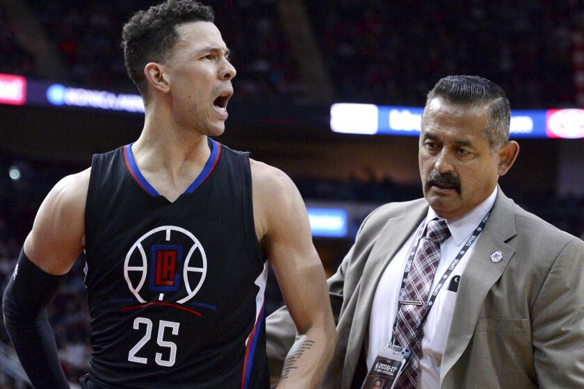Clippers guard Austin Rivers is escorted off the court after being ejected during the second quarter Friday night in Houston.