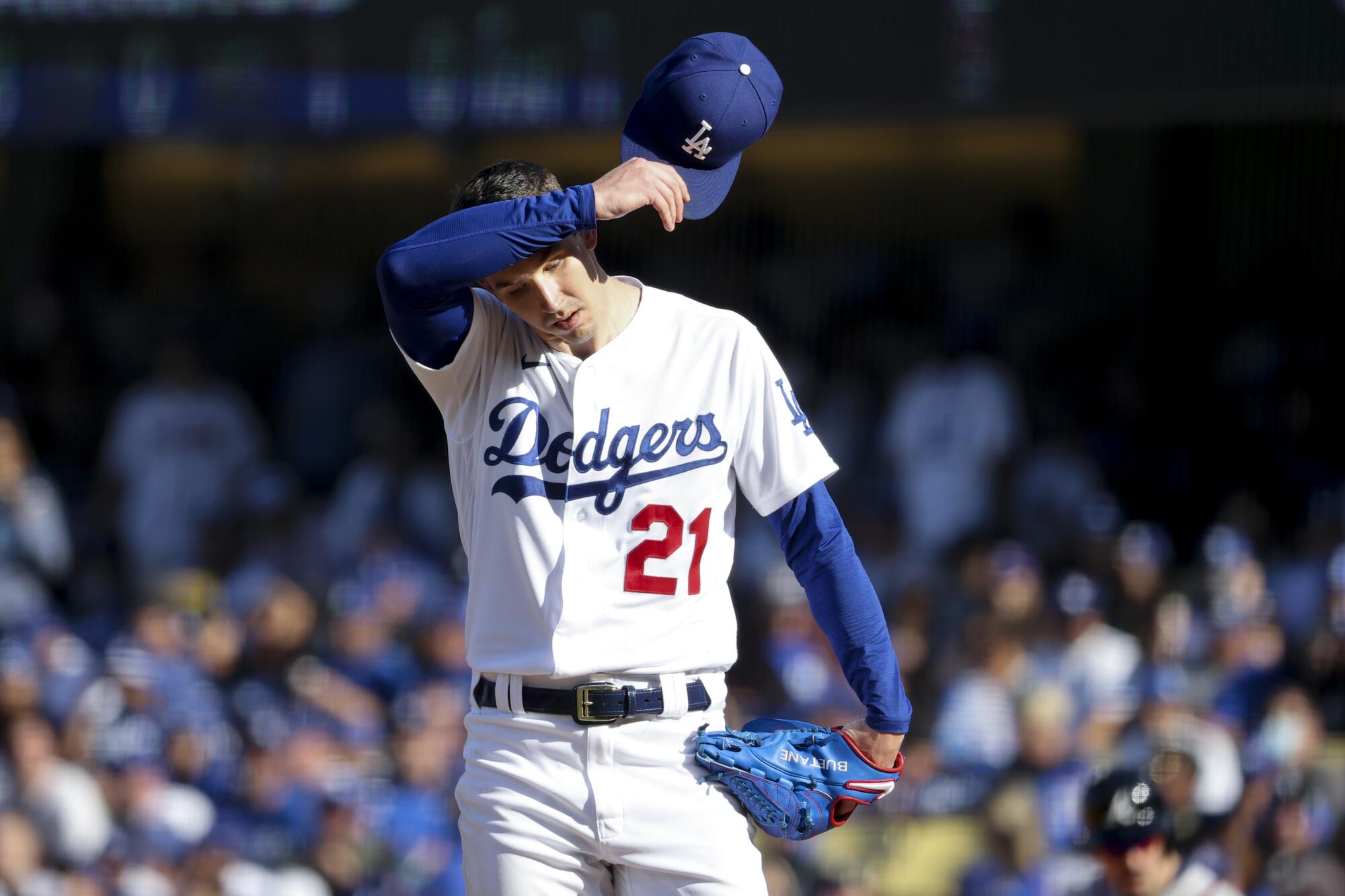 Los Angeles, CA - October 19: Los Angeles Dodgers starting pitcher Walker Buehler wipes his forehead.