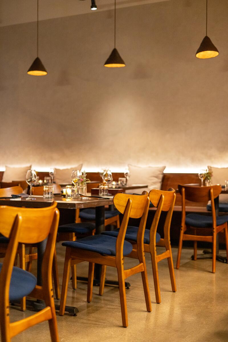 The modern interior of Baroo is roomy and comforting, with warm light surrounding the dining space.