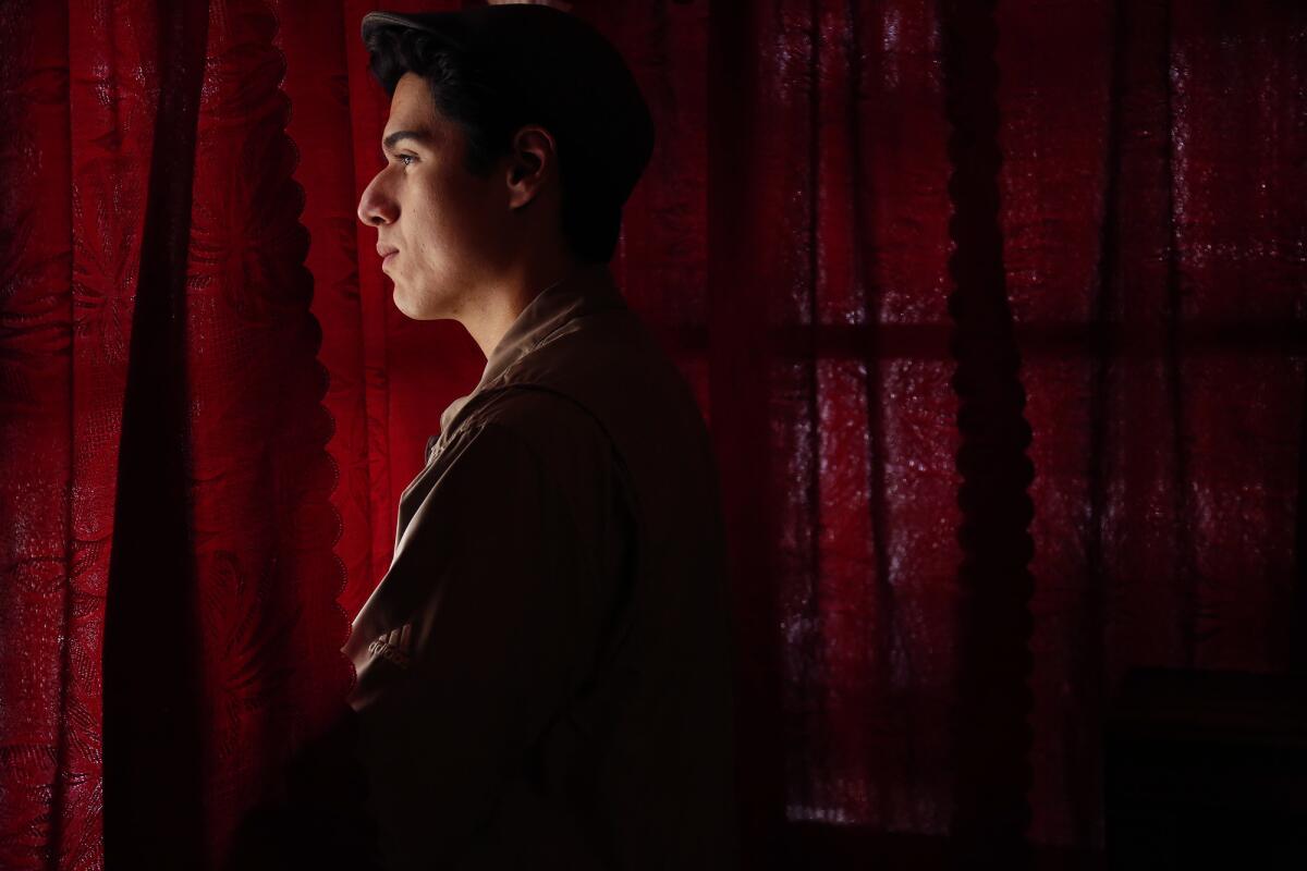 Daniel Garcia, 17, stands inside his bedroom at his grandparents home in the El Sereno neighborhood of Los Angeles on April 6, 2017.