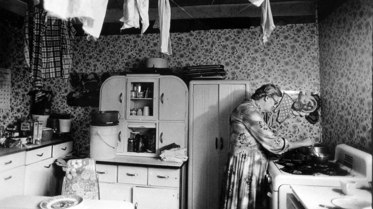 Ada Thompson cooks in her kitchen along Cabin Creek in West Virginia. She collects a total of $4,992 a year counting food stamps.