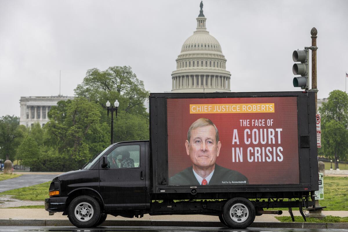 A mobile billboard with a photo of Supreme Court Chief Justice Roberts is seen outside the U.S. Capitol.